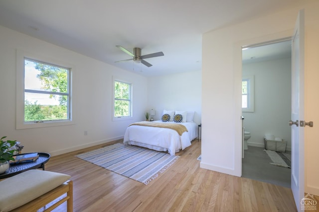 bedroom with ceiling fan, light wood-type flooring, and multiple windows