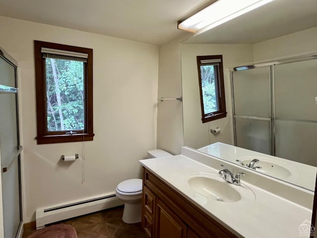 bathroom featuring baseboard heating, plenty of natural light, a shower with door, and toilet