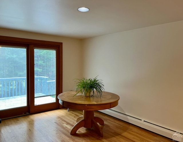 dining area featuring light wood-type flooring and a baseboard radiator