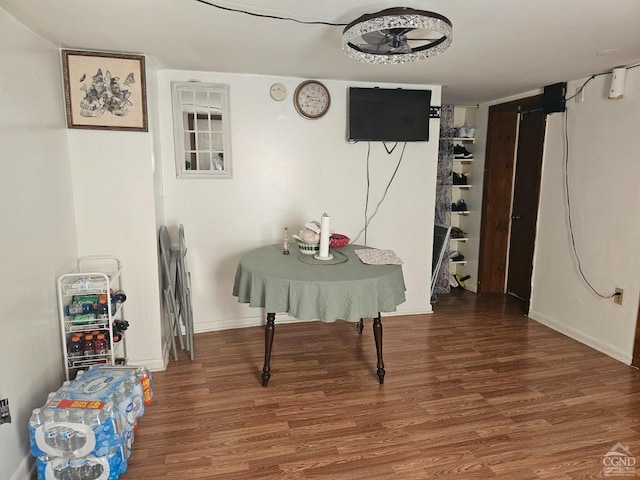 interior space with wood finished floors and baseboards
