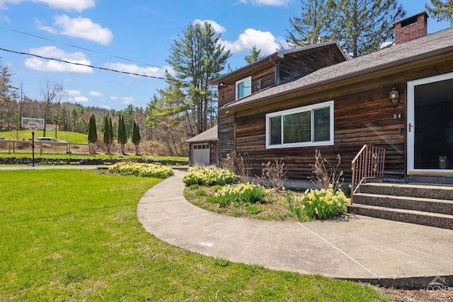 view of side of home with a garage and a yard