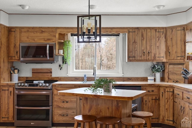 kitchen featuring brown cabinetry and stainless steel appliances