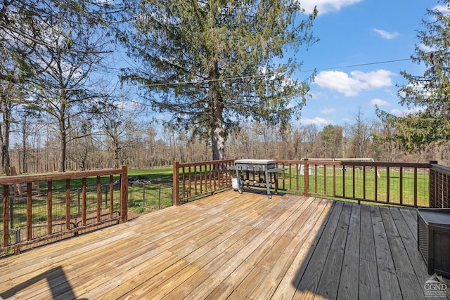 wooden terrace with a lawn