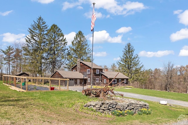 rear view of property with a lawn and a chimney