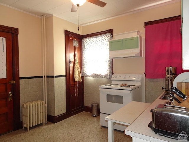 3234 8th St, Hudson, NY 12534 - kitchen featuring radiator heating unit, white range with electric cooktop, tile walls, under cabinet range hood, and ceiling fan
