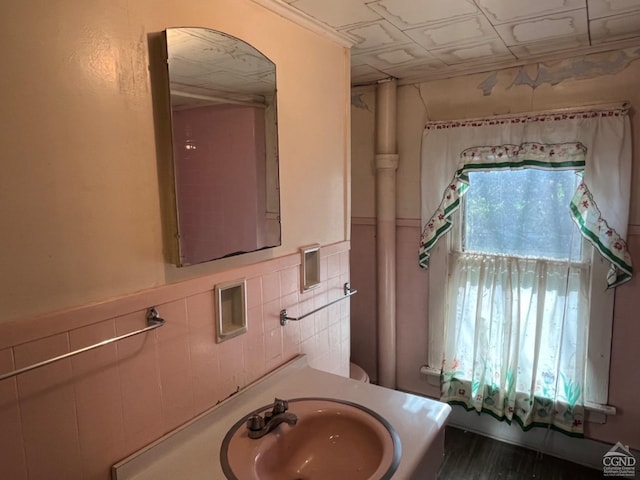 bathroom featuring vanity and tile walls