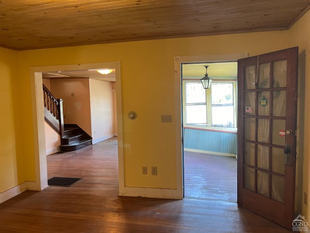 empty room featuring wooden ceiling and dark wood-type flooring