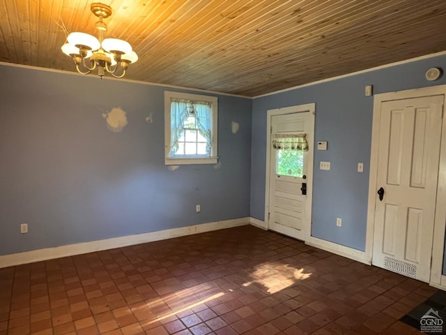 entrance foyer featuring wood ceiling, ornamental molding, and a chandelier