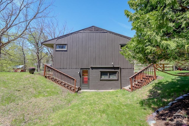 exterior space featuring a lawn and stairs