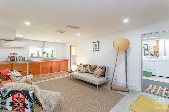 living area with visible vents, an AC wall unit, recessed lighting, and washer and dryer