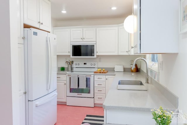 kitchen featuring ornamental molding, white appliances, light countertops, white cabinetry, and a sink