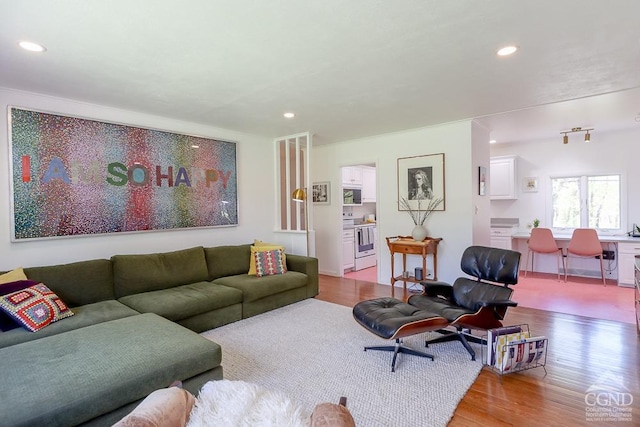 living area with recessed lighting and wood finished floors
