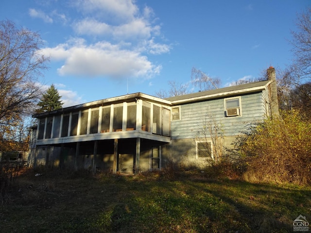 back of house with a sunroom