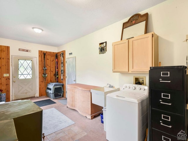 laundry area featuring cabinets, washer / dryer, a textured ceiling, and sink