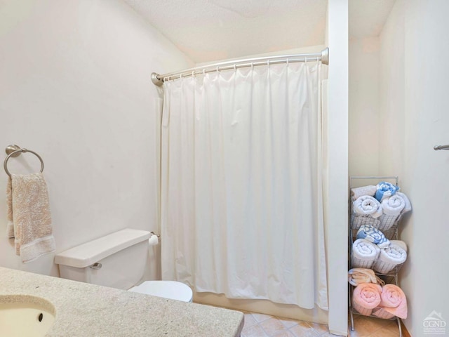 bathroom featuring toilet, sink, and vaulted ceiling