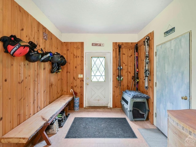 mudroom with wooden walls