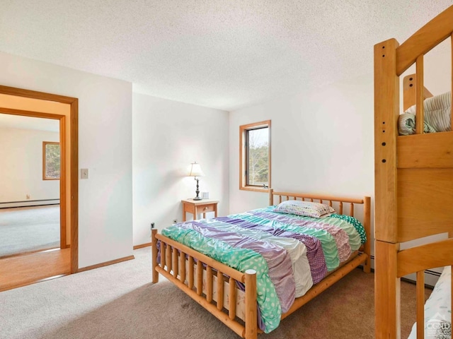 carpeted bedroom featuring a textured ceiling and a baseboard radiator