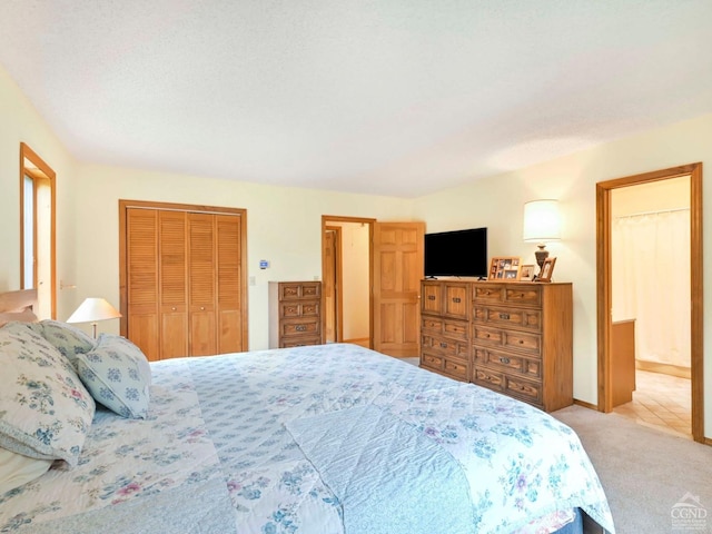 carpeted bedroom featuring a textured ceiling and a closet