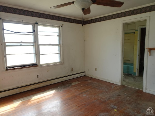 spare room featuring baseboard heating, wood finished floors, and a ceiling fan