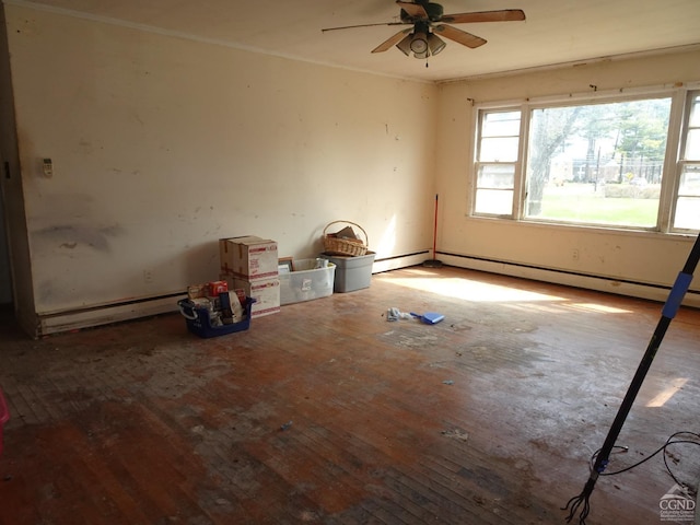 empty room with baseboard heating, ceiling fan, and hardwood / wood-style flooring