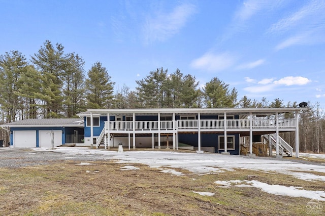 view of front of property with an attached garage and stairs