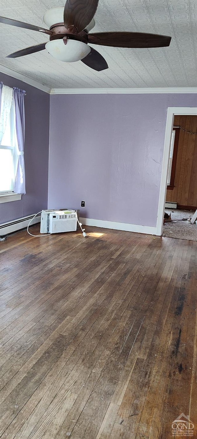 empty room featuring ornamental molding, baseboards, a ceiling fan, and hardwood / wood-style floors