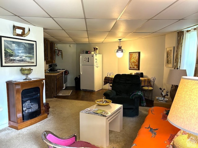 carpeted living room with a paneled ceiling