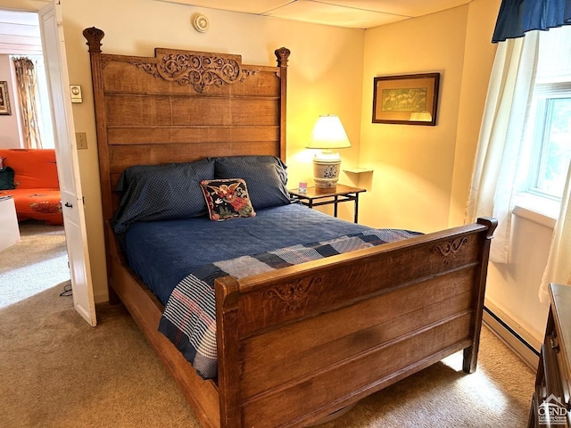 bedroom featuring light colored carpet and baseboard heating