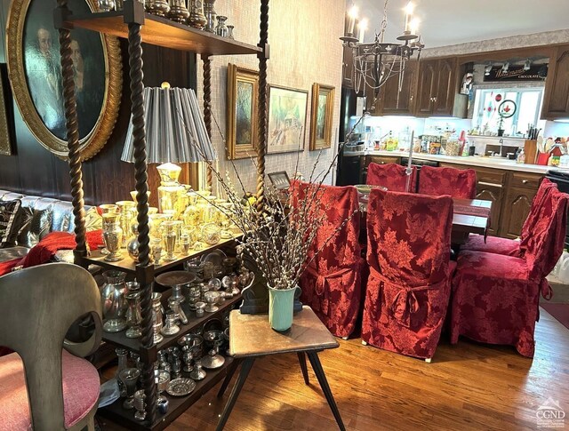 dining area featuring a chandelier, hardwood / wood-style floors, and sink