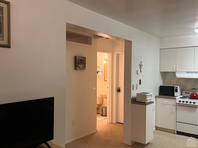 kitchen with white cabinets, white appliances, exhaust hood, and tasteful backsplash