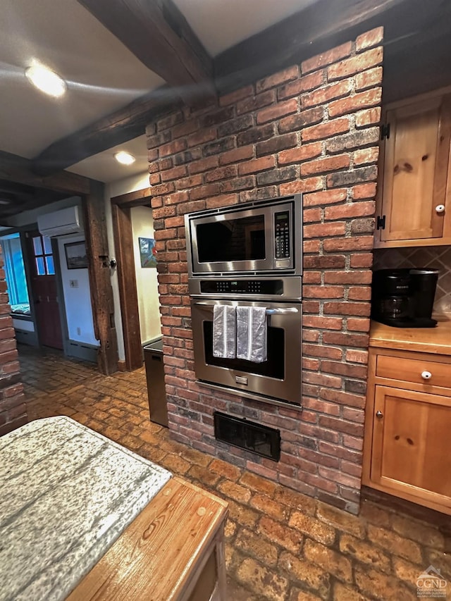 kitchen featuring beamed ceiling, backsplash, stainless steel appliances, and a wall mounted AC