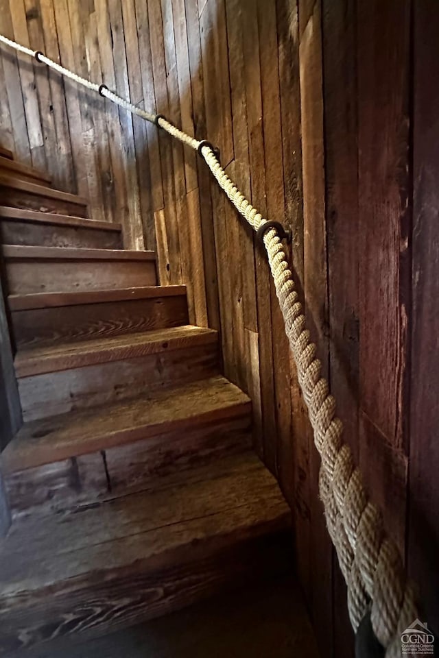 stairway with wood walls