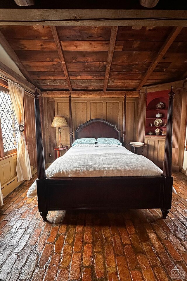 unfurnished bedroom with lofted ceiling with beams, wooden walls, and wooden ceiling