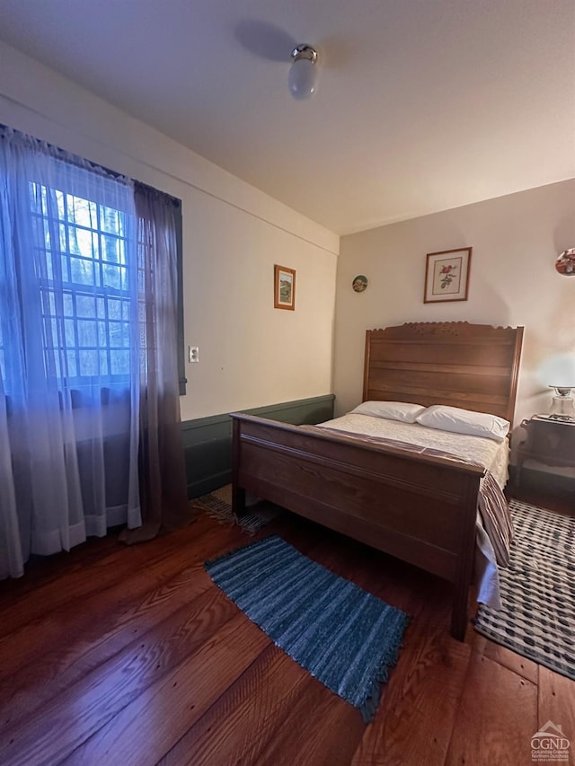 bedroom with dark wood-type flooring