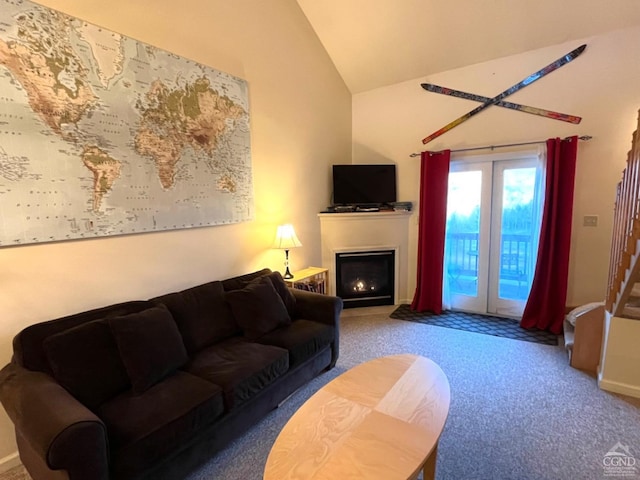 carpeted living room with french doors and lofted ceiling