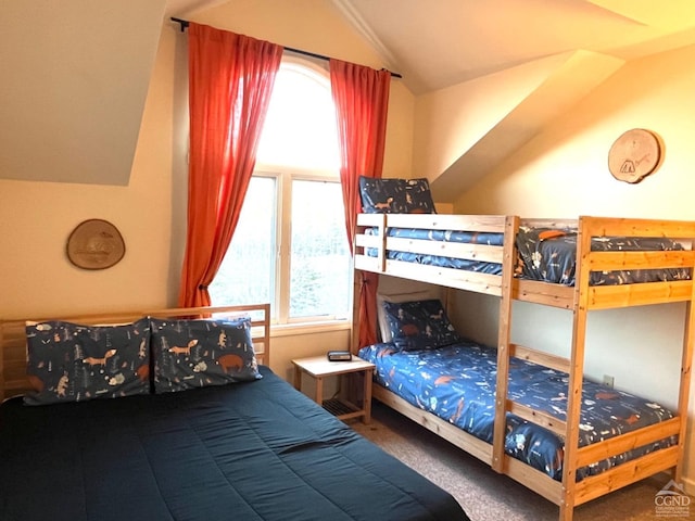 carpeted bedroom with vaulted ceiling