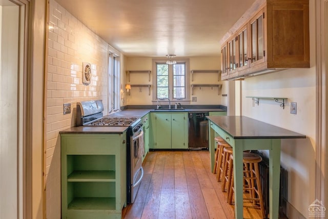 kitchen with open shelves, dark countertops, black dishwasher, green cabinetry, and stainless steel range with gas stovetop