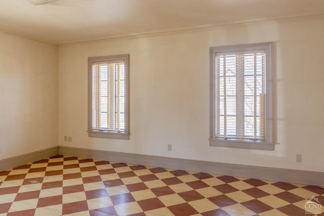 unfurnished room featuring baseboards, light floors, and ornamental molding