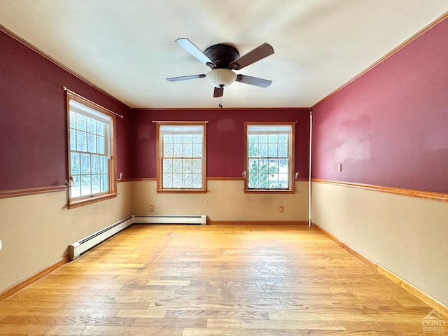 spare room with ceiling fan, a healthy amount of sunlight, and light wood-type flooring