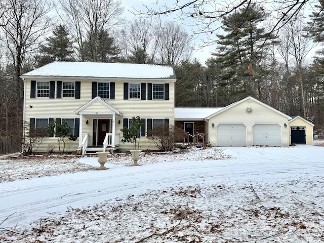 view of front of house with a garage and an outdoor structure