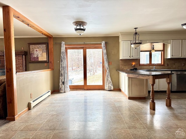 kitchen with a baseboard radiator, pendant lighting, a wealth of natural light, crown molding, and stainless steel dishwasher