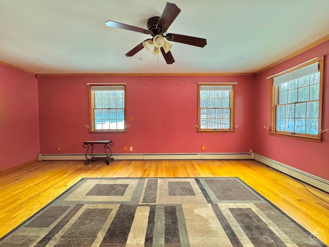 spare room with ceiling fan, crown molding, and light wood-type flooring