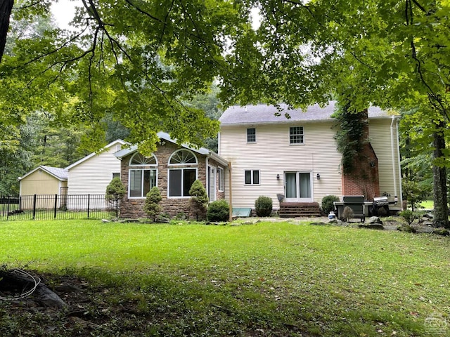 rear view of house featuring a lawn