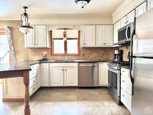 kitchen with plenty of natural light, sink, stainless steel appliances, and pendant lighting