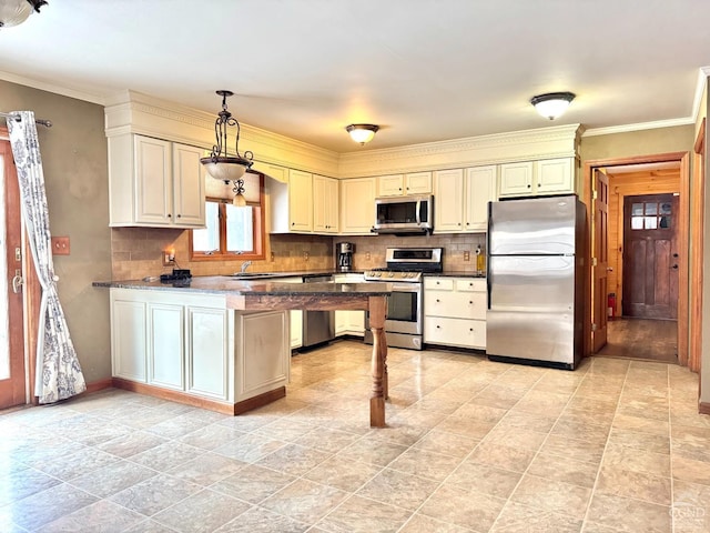 kitchen featuring hanging light fixtures, kitchen peninsula, appliances with stainless steel finishes, and crown molding