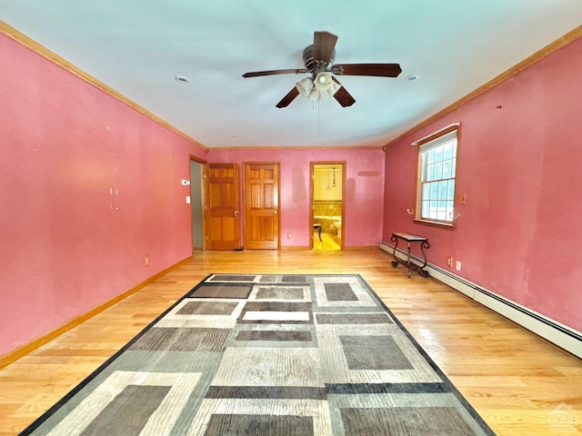 interior space featuring ceiling fan, crown molding, a baseboard radiator, and hardwood / wood-style floors