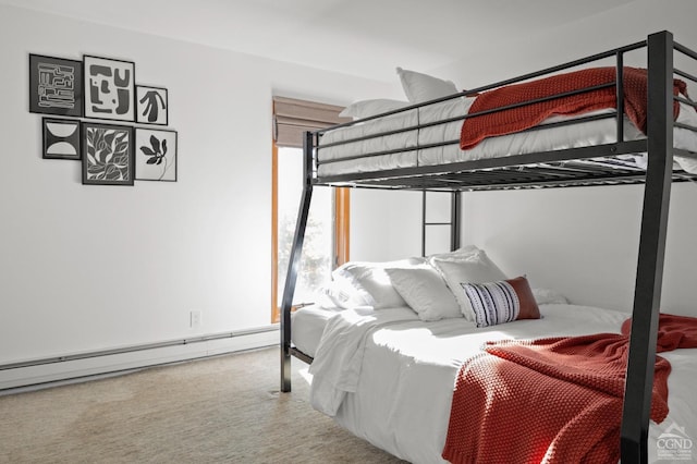 bedroom with carpet flooring and a baseboard heating unit