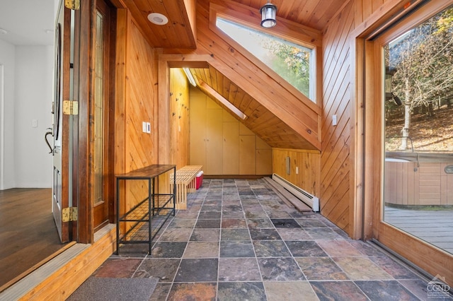 additional living space featuring wooden ceiling, lofted ceiling with skylight, wooden walls, and a baseboard radiator