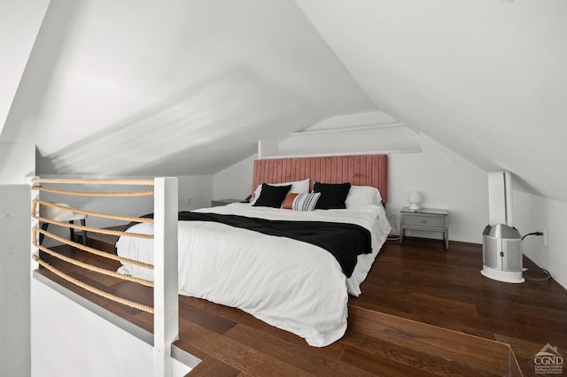 bedroom with dark wood-type flooring and lofted ceiling