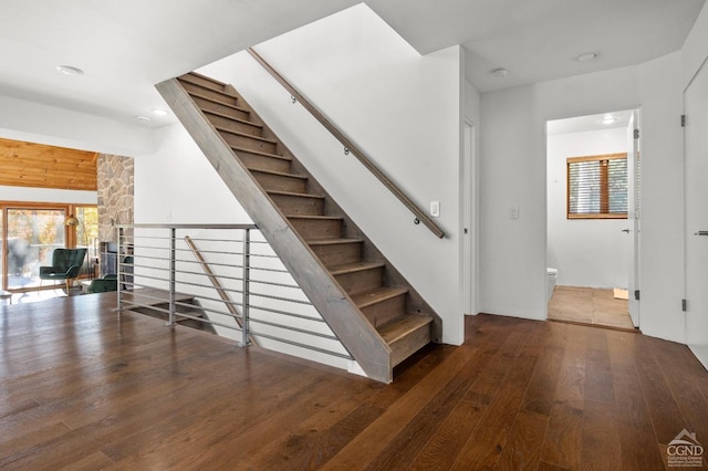 staircase with hardwood / wood-style floors